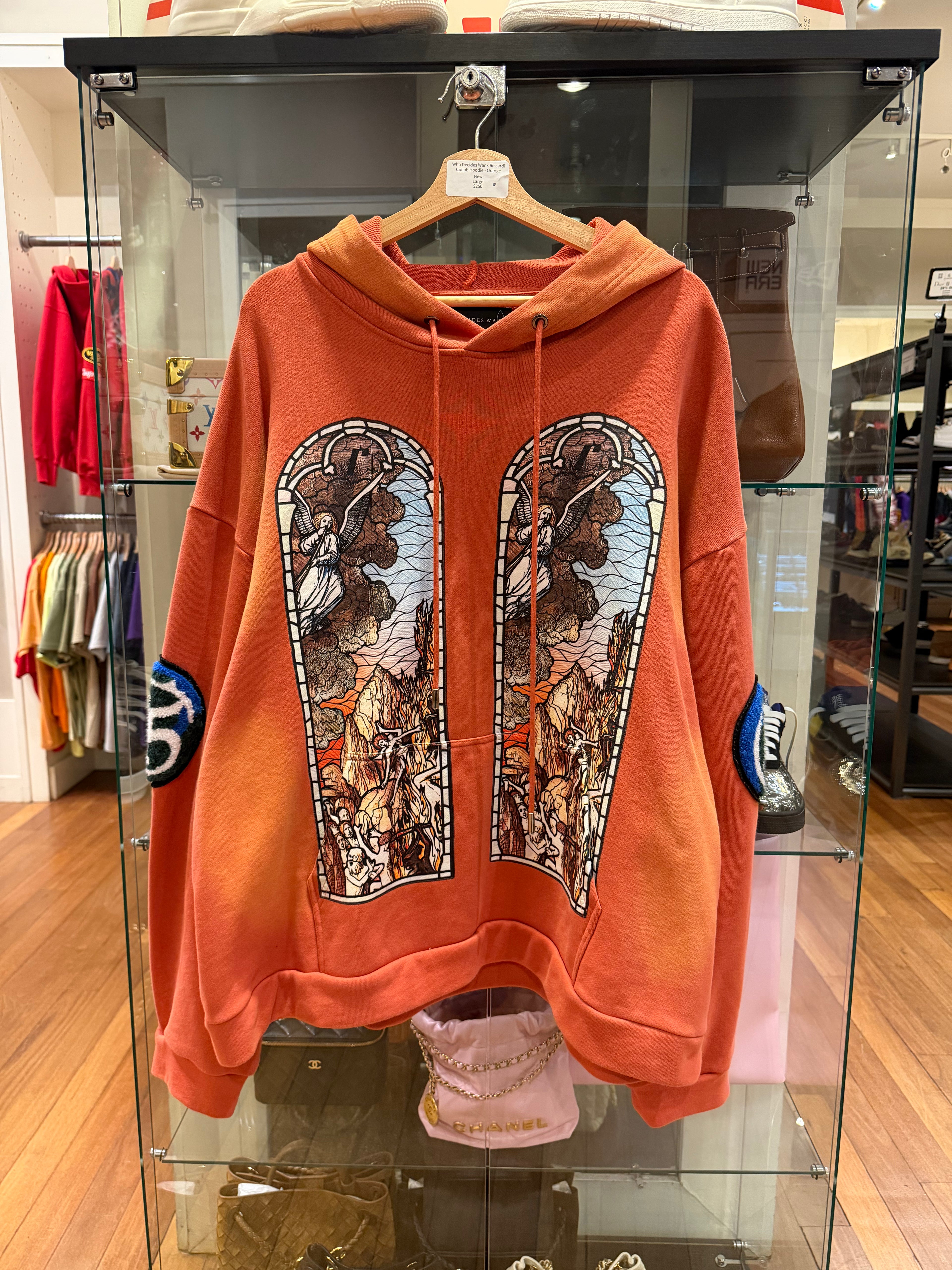 Who Decides War x Ricardi
Collab Hoodie - Orange